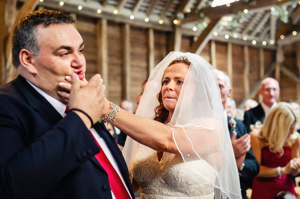 Bride wipes lipstick off a grooms face