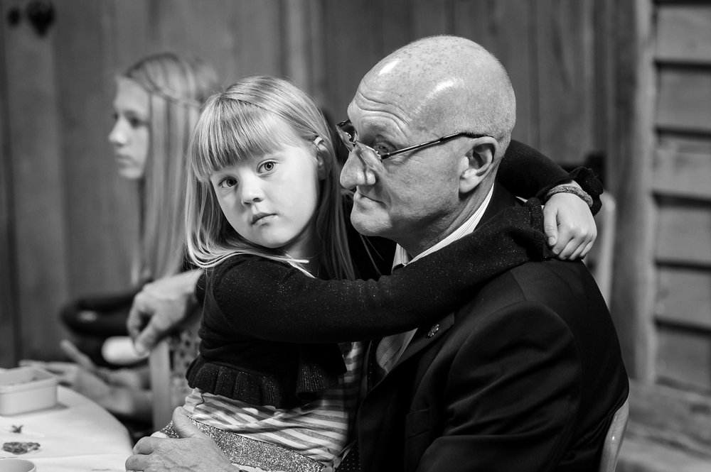 Girl hugs her grandfather at Berkshire wedding