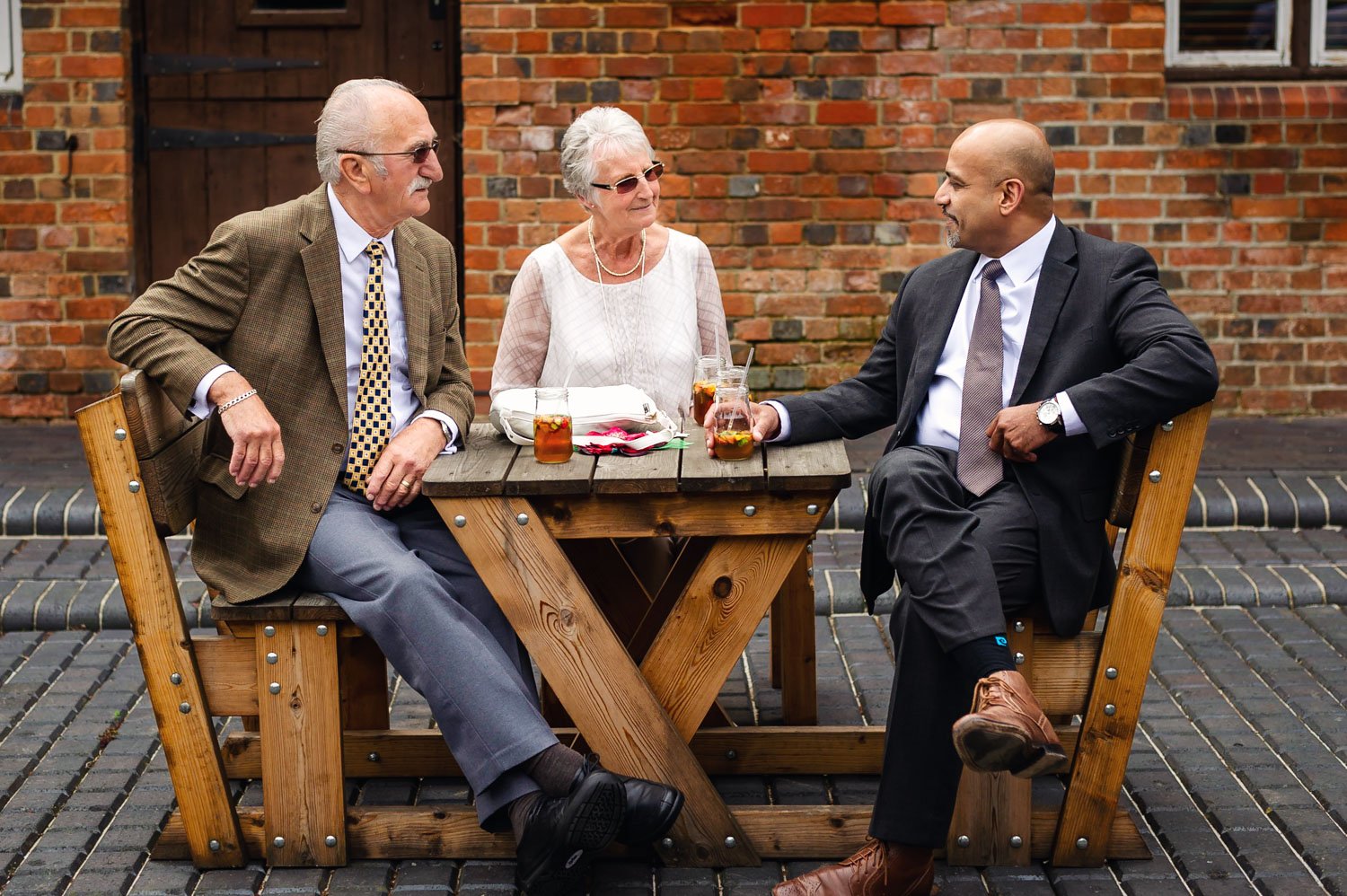 Guests chat over drinks at a summer Berkshire wedding