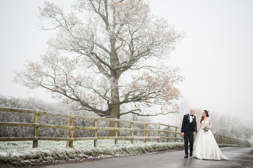  Bride and groom in the  snow at Milling Barn. Hertfordshire 