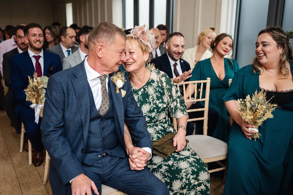 Parents of the bride hold hands at Millbridge Court