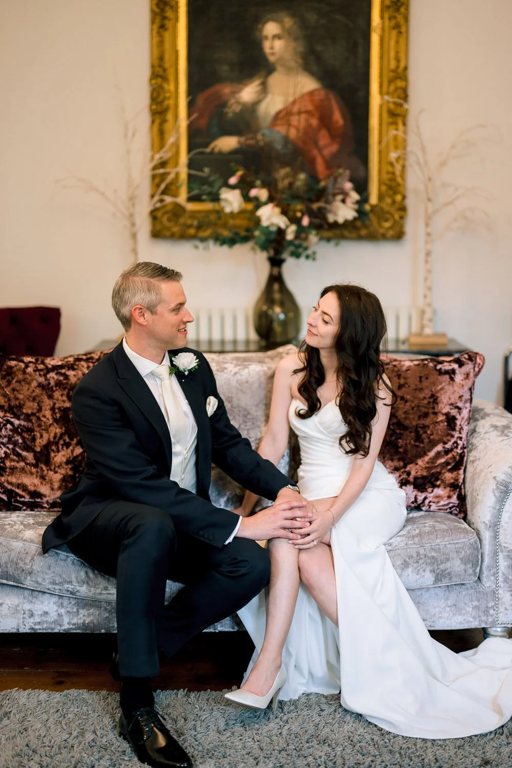 A bride and groom relax in the luxury surrounds of Hutton Hall Drawing Room Essex