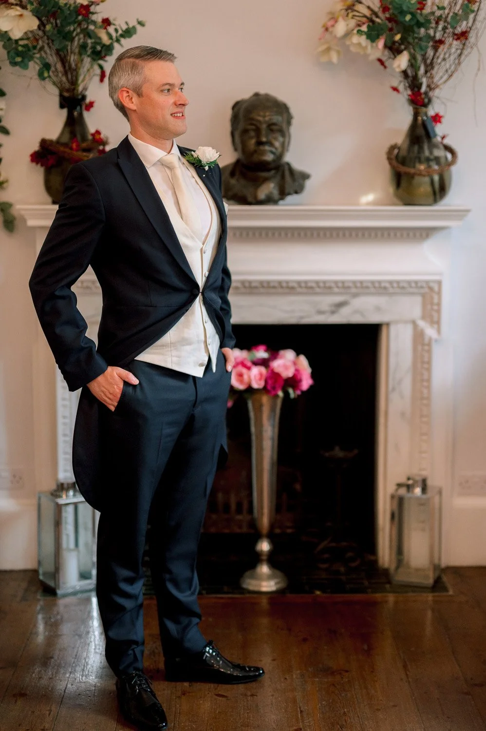 A groom stands by the fire at Hutton Hall Essex