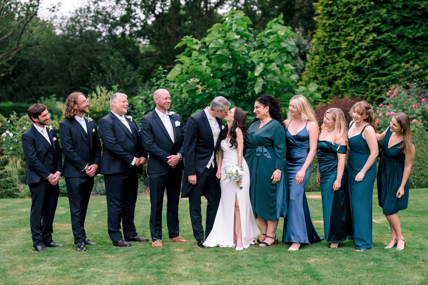 Groomsmen and Bridesmaids line up for a group shot at Hutton Hall in Essex