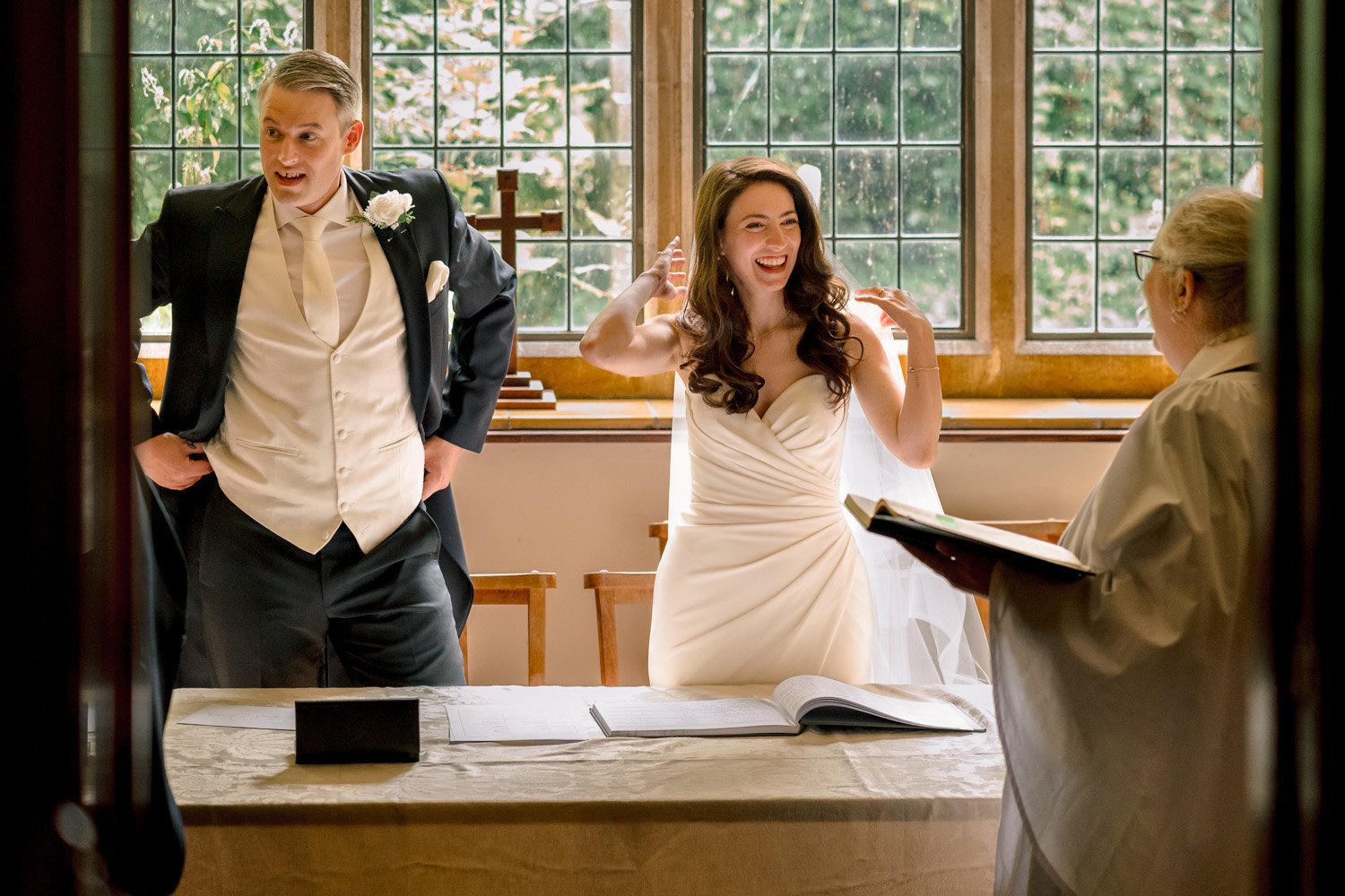A bride and groom prepare to sign the register at All Saints Church Hutton
