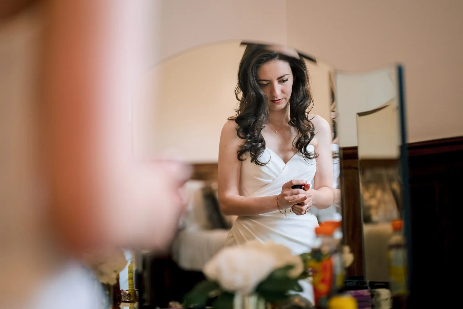 A bride puts the finishing touches to her wedding preparations at Hutton Hall
