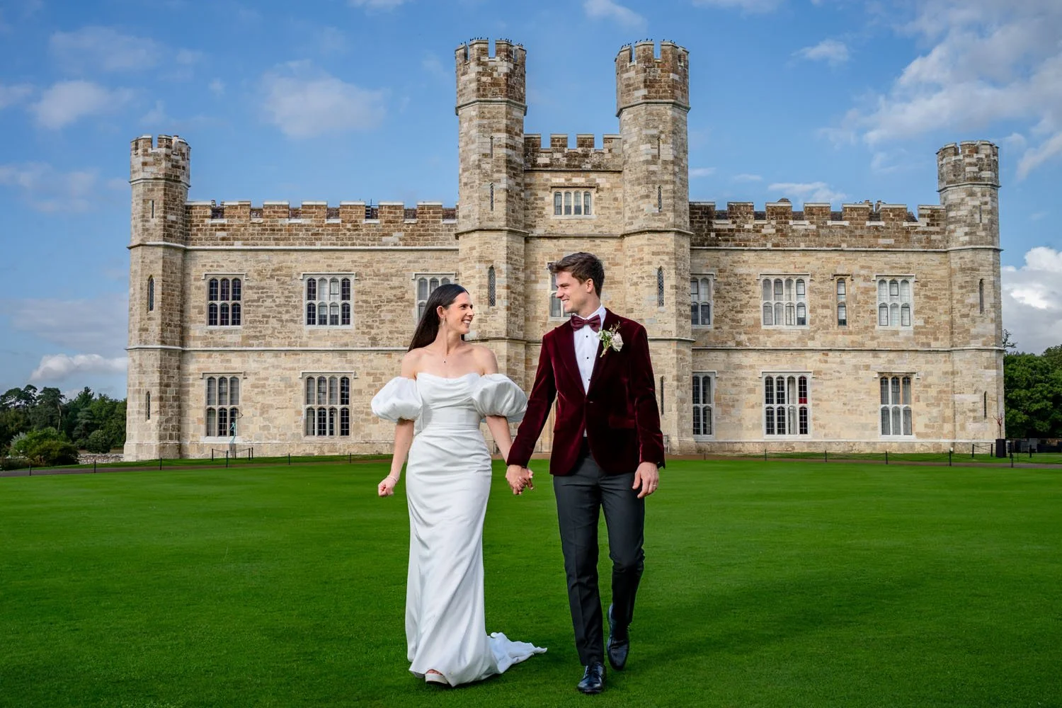 Bride and groom in front of Leeds Castle in Kent, photographed by Steve Bagness, documentary wedding photographer.
