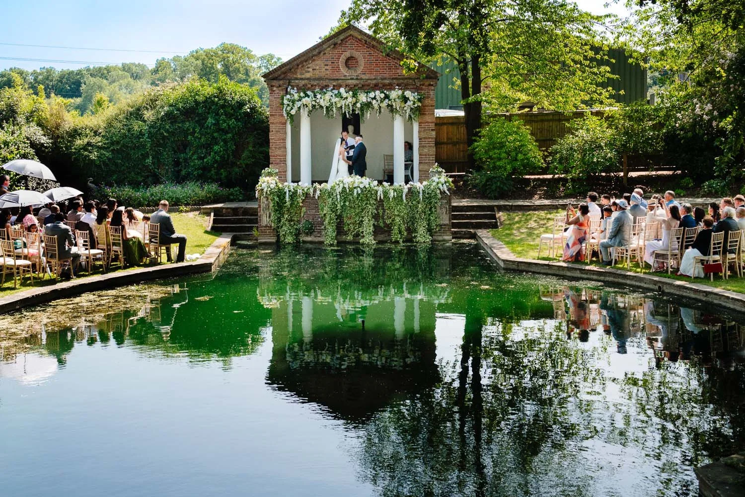 An outdoor wedding ceremony taking place at Micklefield Hall in Rickmansworth