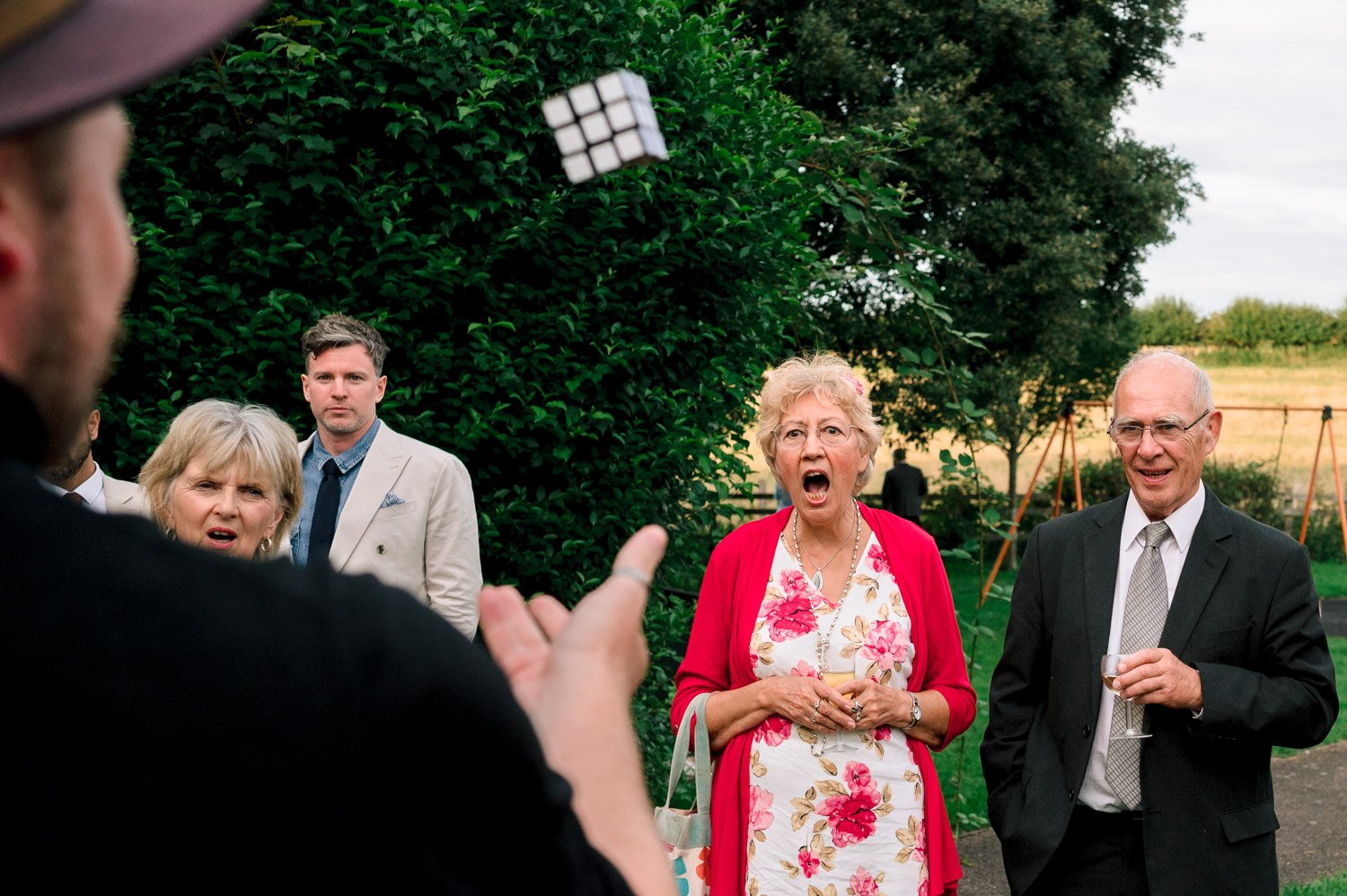 A wedding guest open mputhed at a magicians trick photographed by Uxbridge wedding photographer Steve Bagness