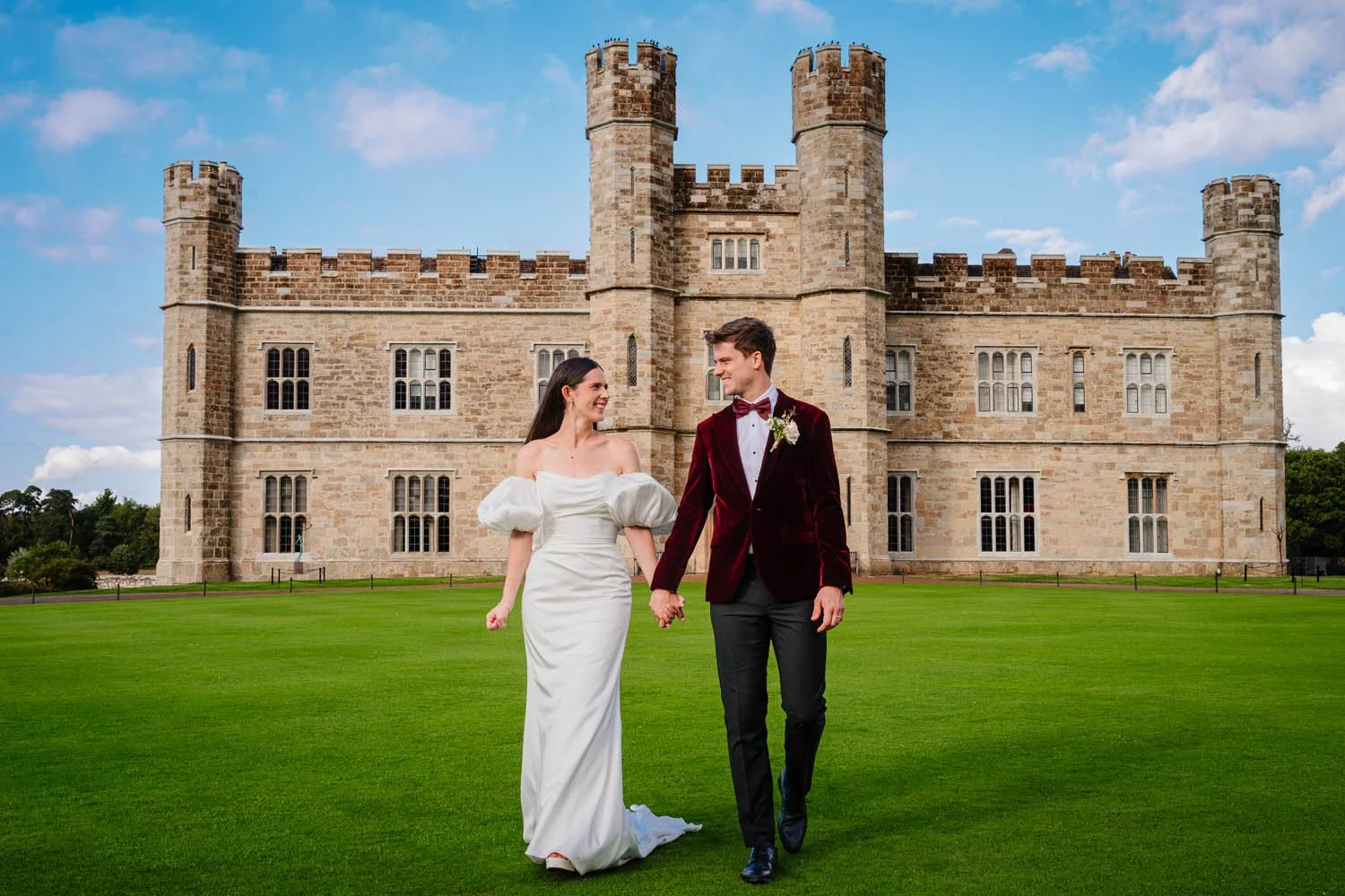 Bride and groom in front of Leeds Castle in Kent, photographed by steve Bagness, documentary wedding photographer