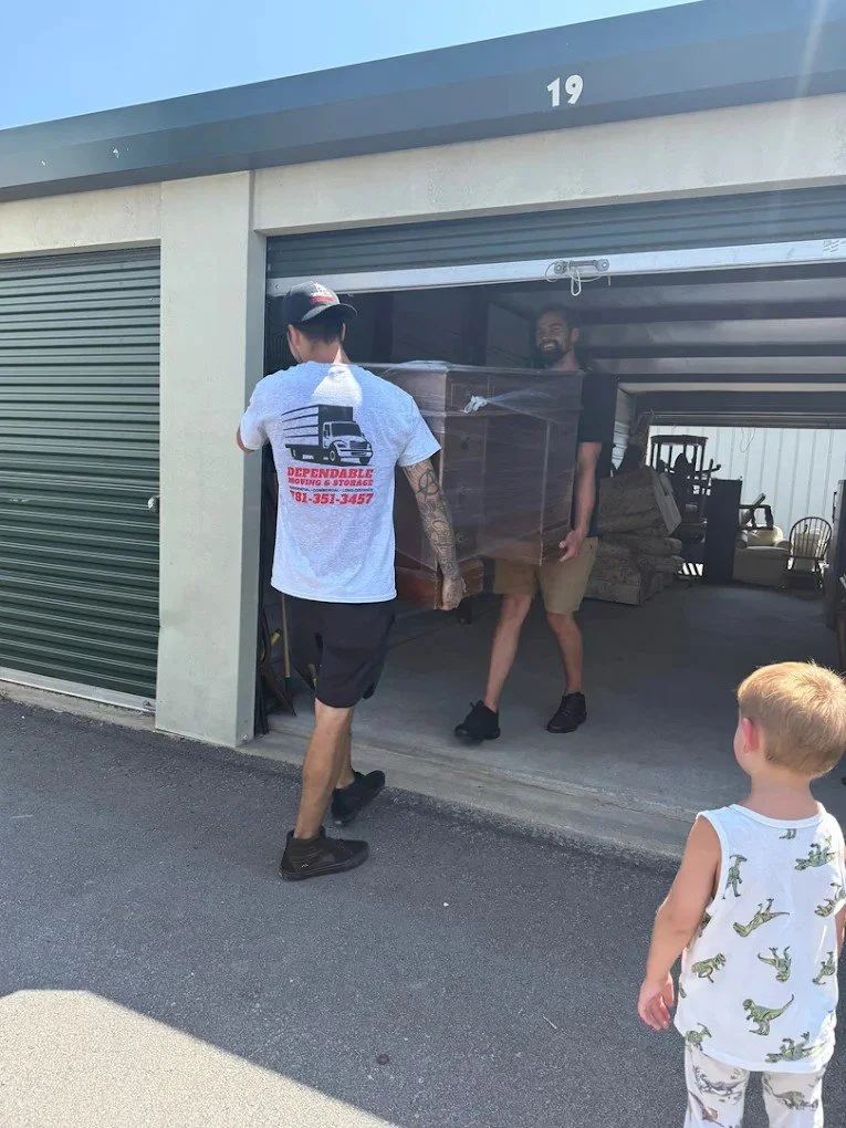 Men moving furniture into storage 