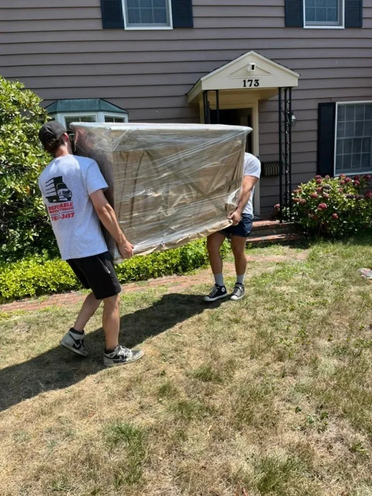 Men moving furniture into home 