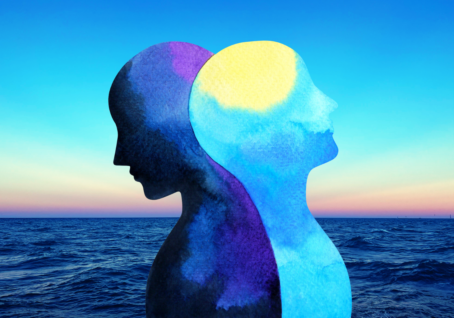 Two overlapping human silhouettes in watercolor tones of deep purple and luminous blue against an open ocean and sunset sky, representing the spectrum of expression within a single astrological placement.