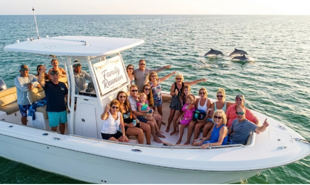 Family reunion group on Panama City Beach boat tour watching dolphins