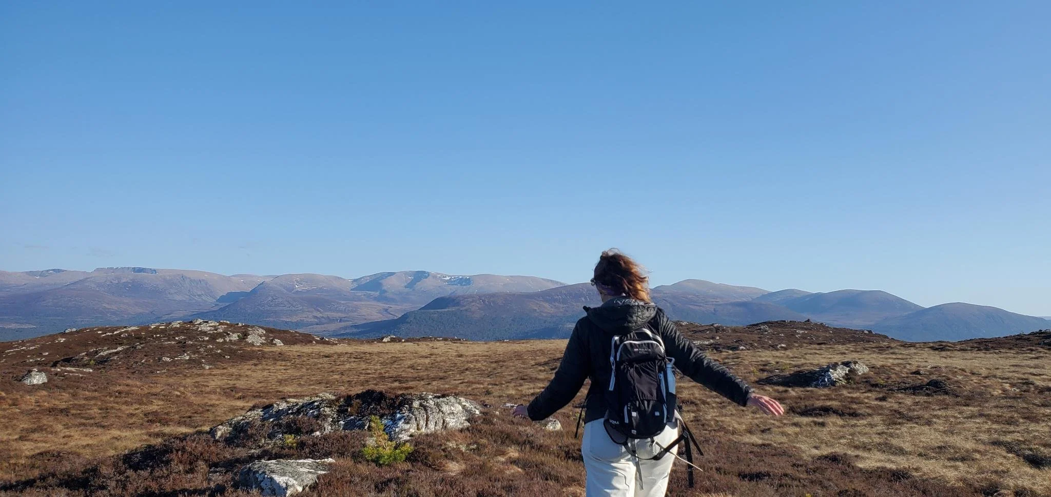 A woman walks on the mountains of Aviemore, Scotland