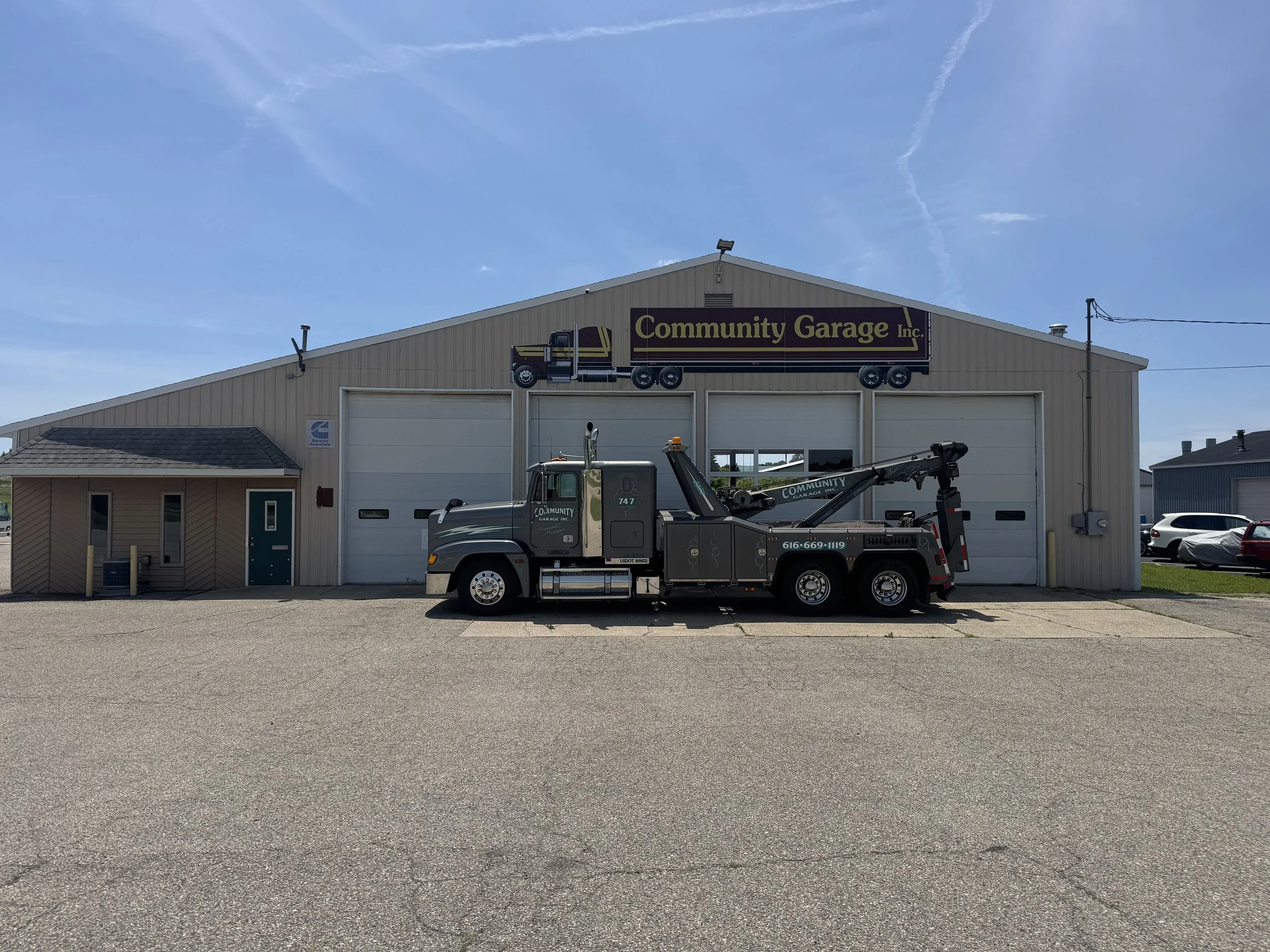 A diesel repair shop, with a company wrecker/tow truck that both read community garage.