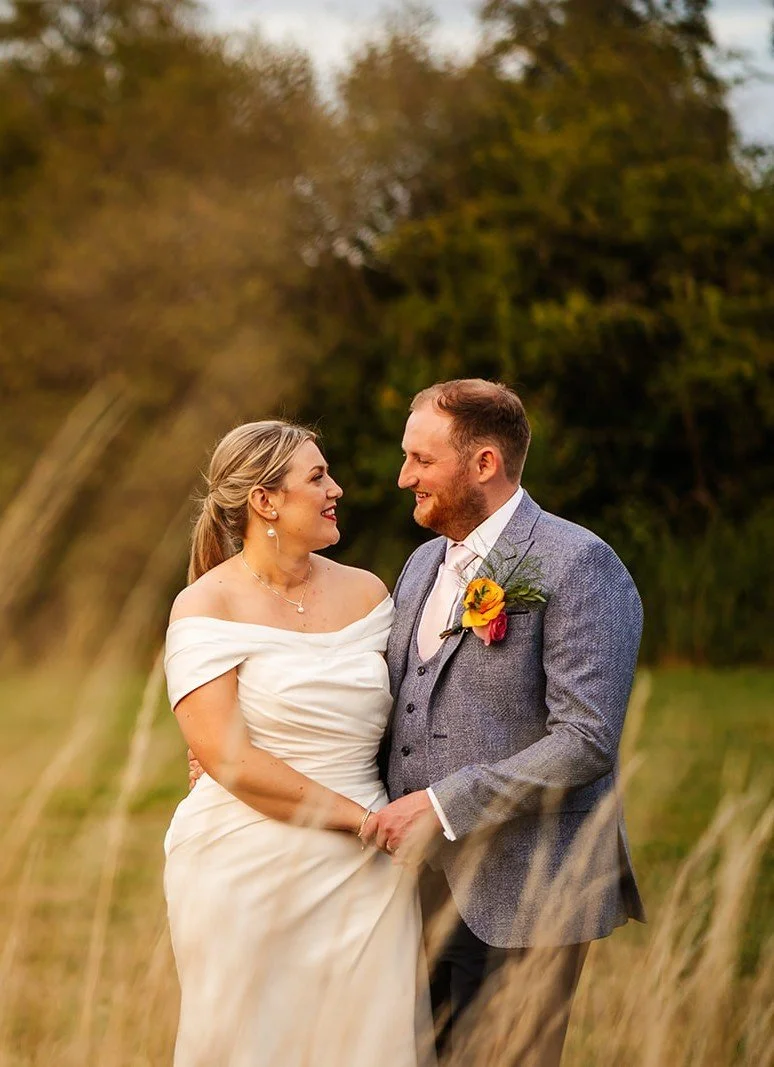 bride and groom sunset photo in field.jpg