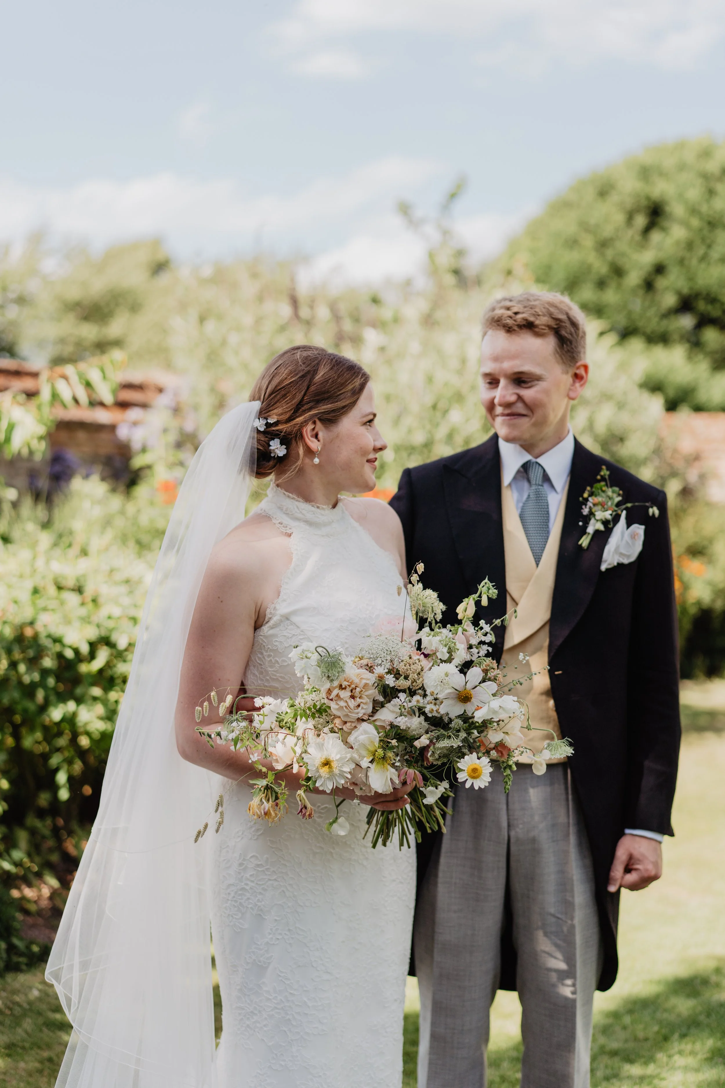 bride and groom looking at eachother in garden.jpg