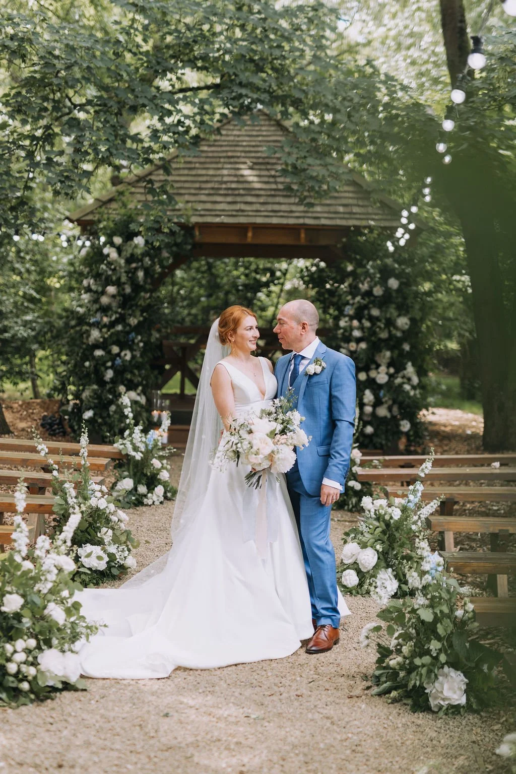 bride and groom in the aisle with flowers.jpg