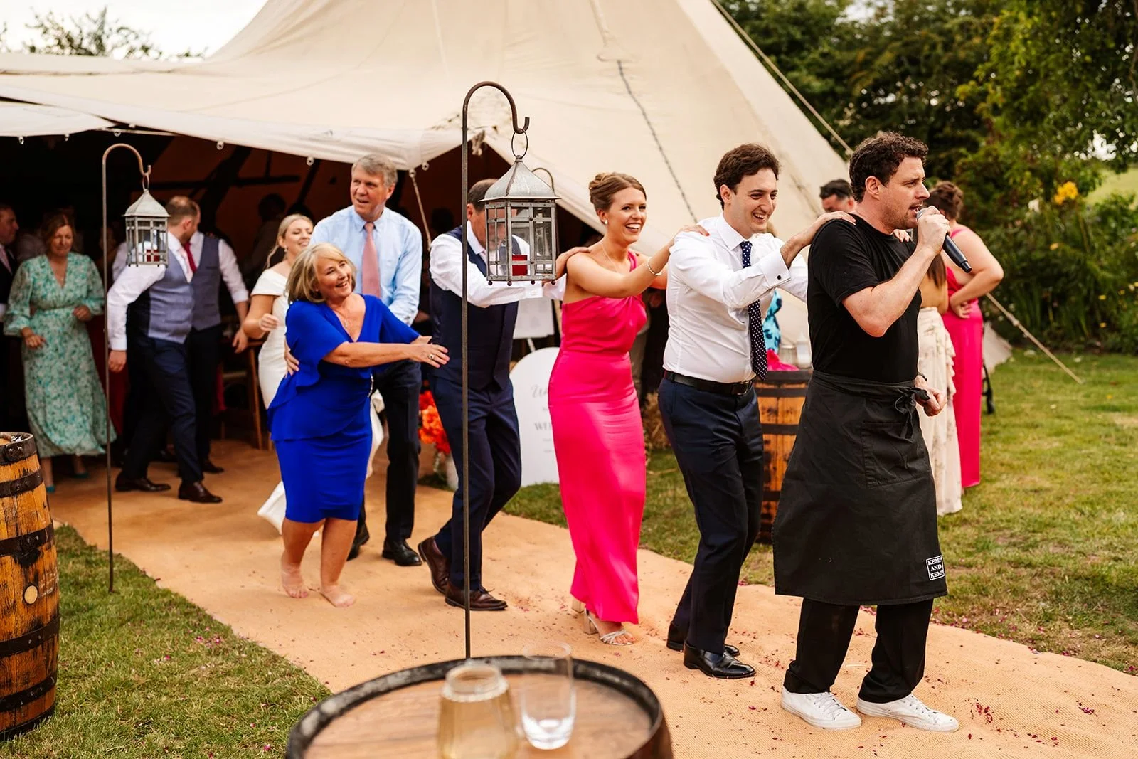 singing waiters leading conga tipi wedding