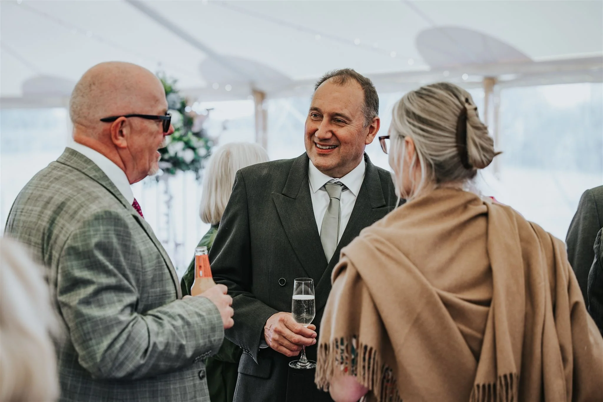 Guests enjoying drinks reception inside marquee