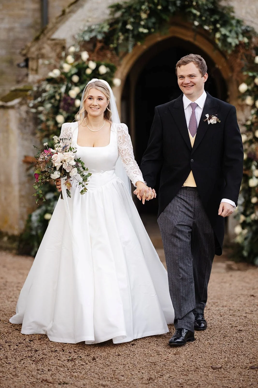bride and groom exiting the church after winter ceremony