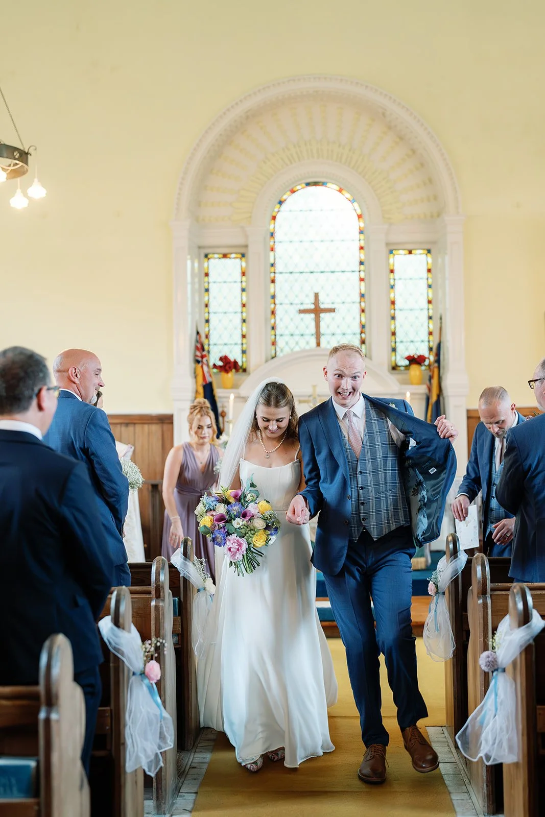 bride and groom walking back down the aisle after church ceremony.jpg