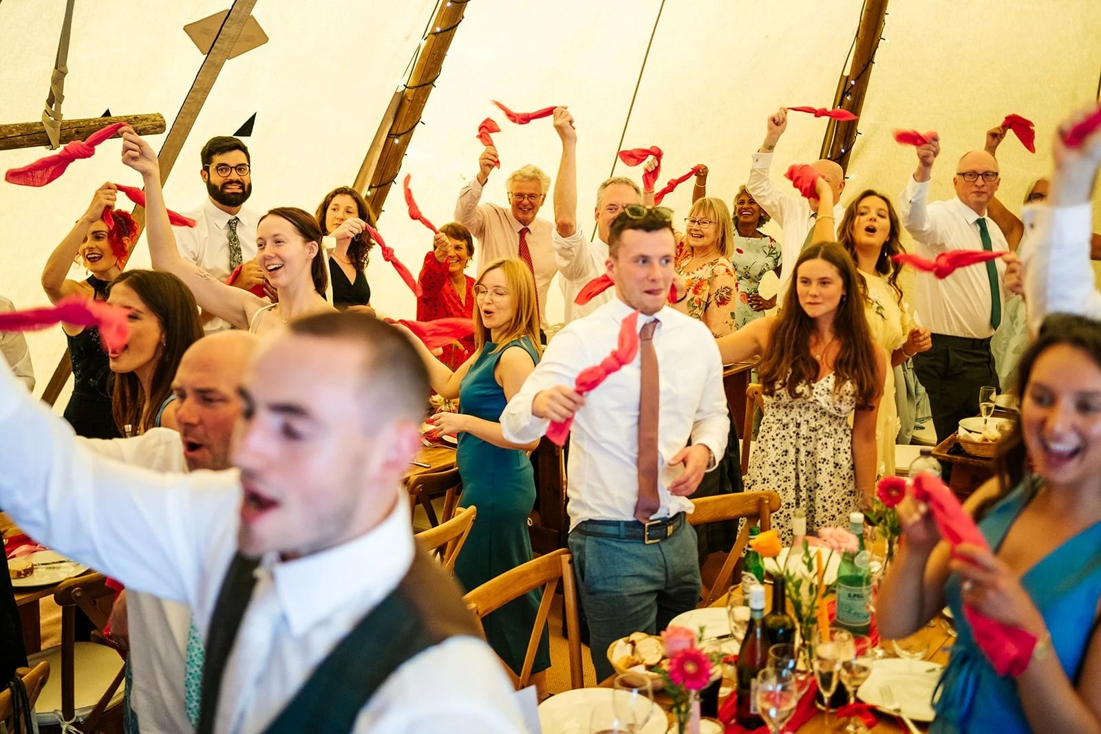wedding guests swinging napkins tipi wedding