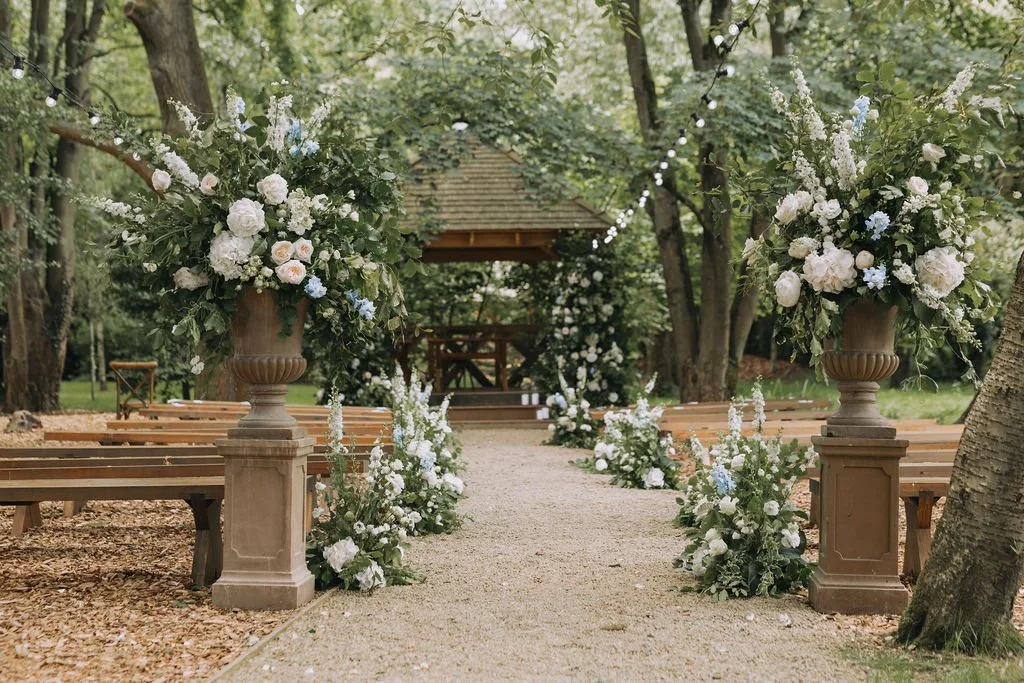 woodland aisle ceremony set up with floral meadows