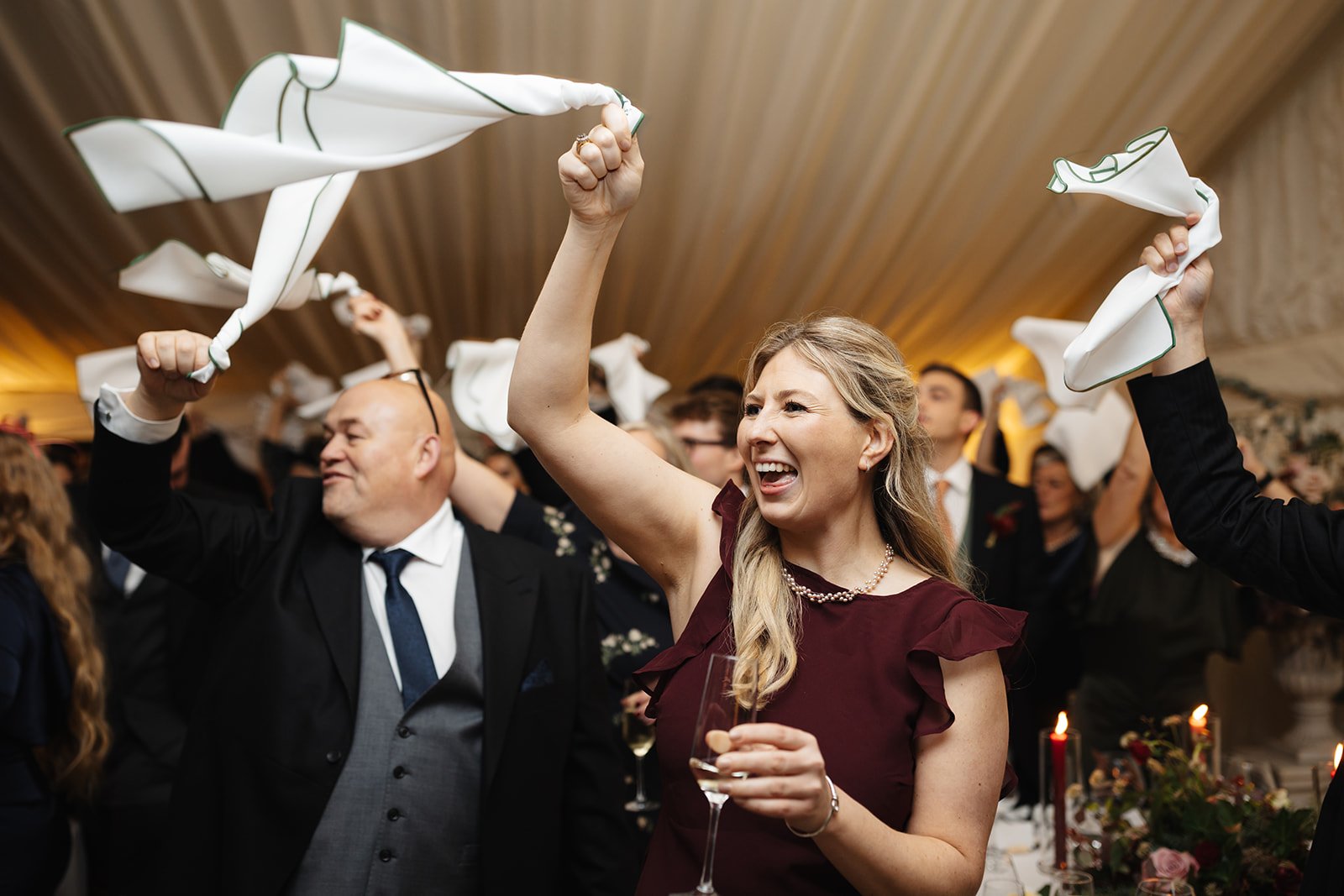 guests swinging napkins for bride and groom entrance.