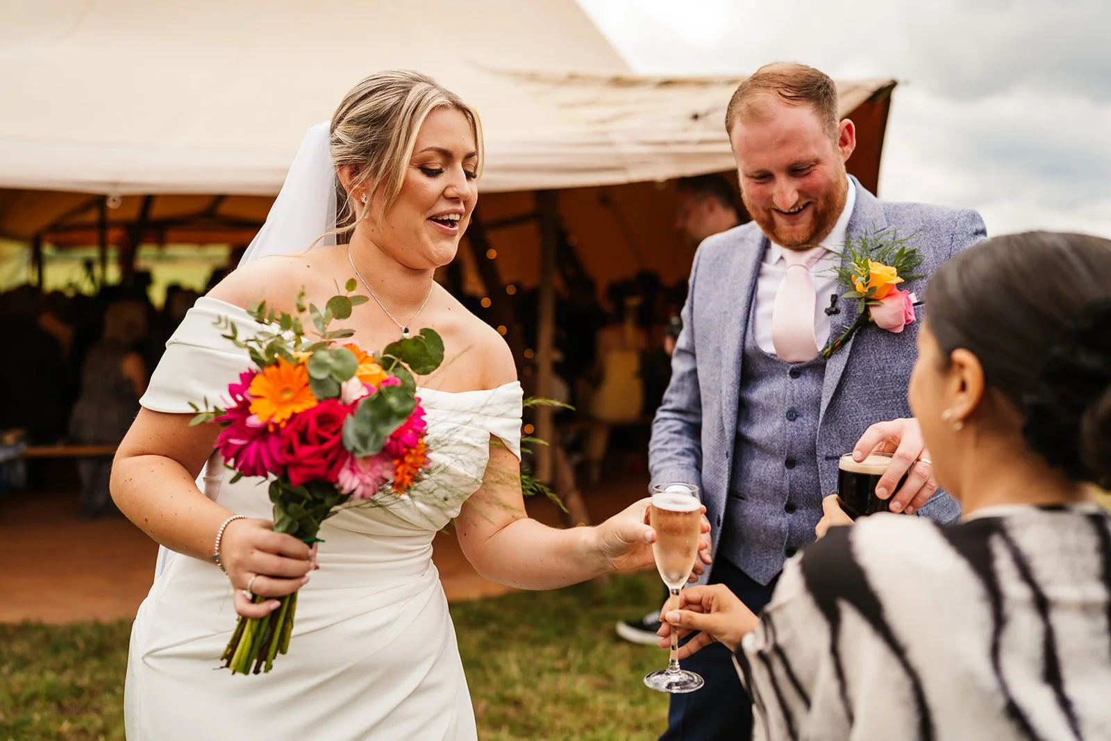 wedding planner giving just married couples first drinks