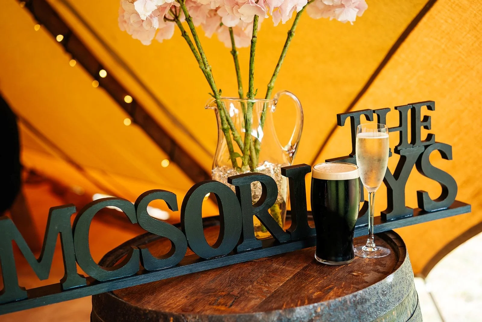 surname sign with just married drinks