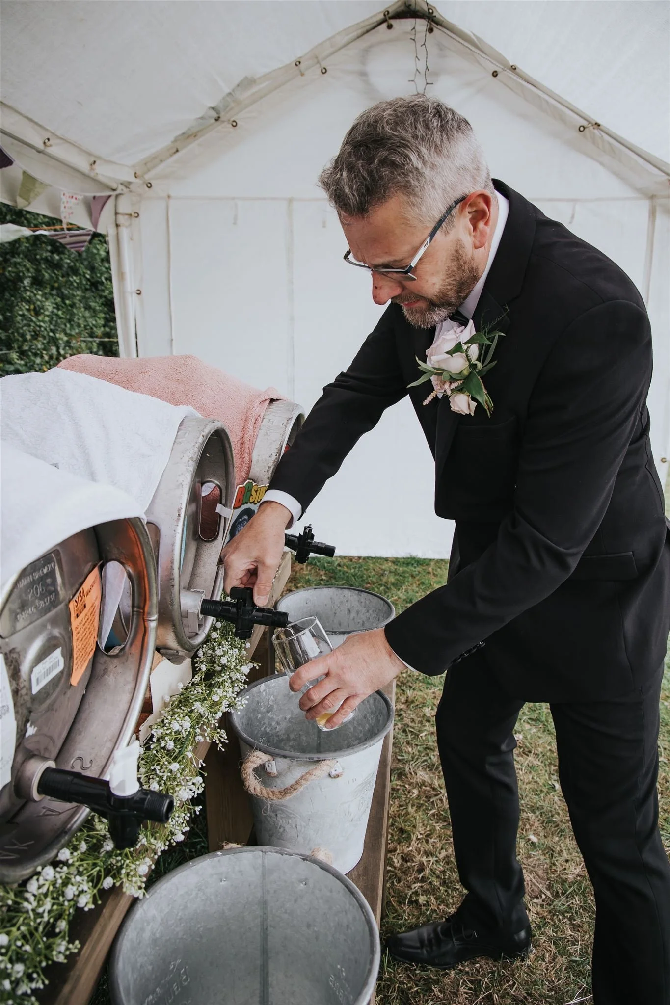 Guest pouring beer from homemade kegs