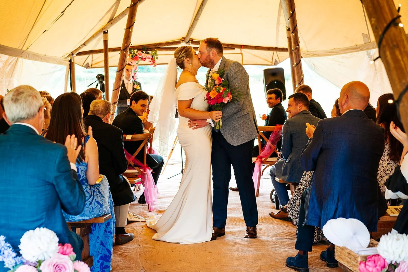 bride and groom first kiss after ceremony in tipi