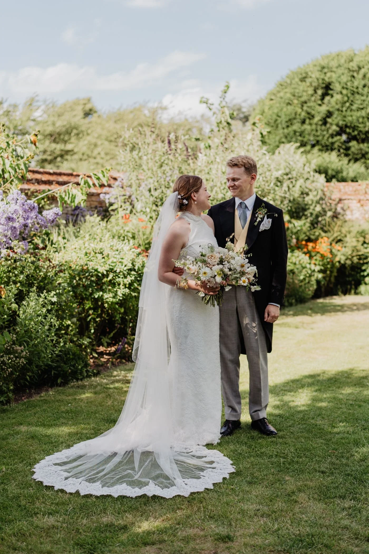 Bride and groom looking at each other smiling