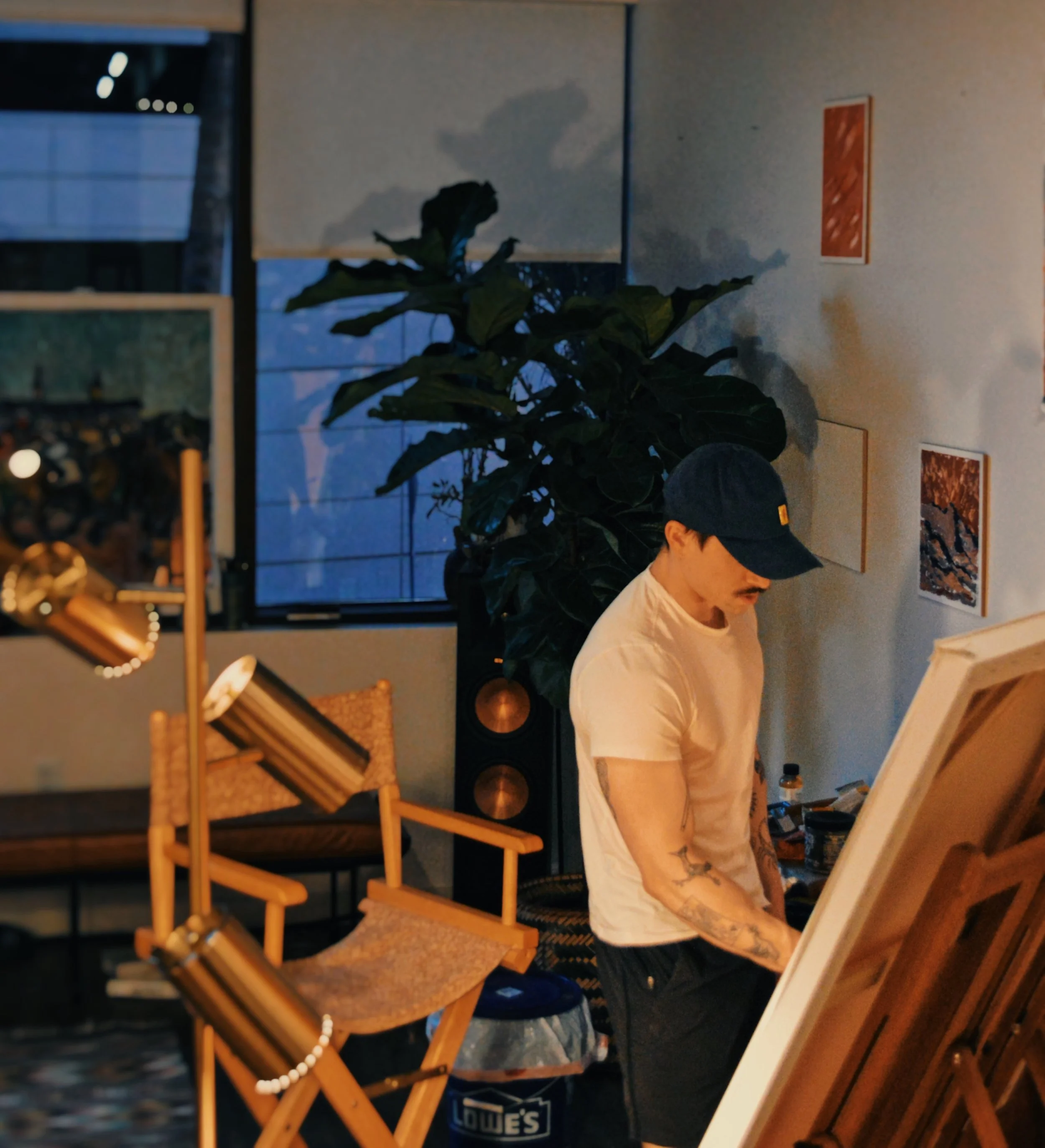 Kevin Koza standing at the easel, painting in his studio.