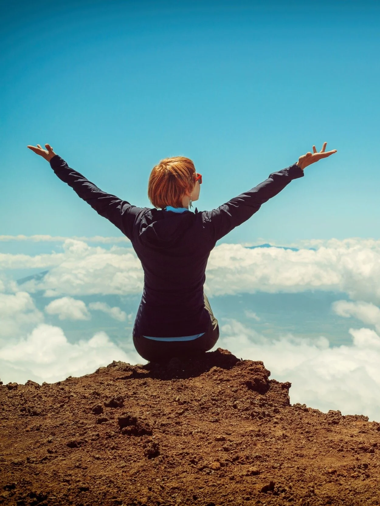 Photo of a woman sitting on top of a mountain with her arms reaching up expressing freedom. Do you struggle with sex as a highly sensitive person? Discover how sex therapy in Atlanta, GA can help you start connecting more intimately.