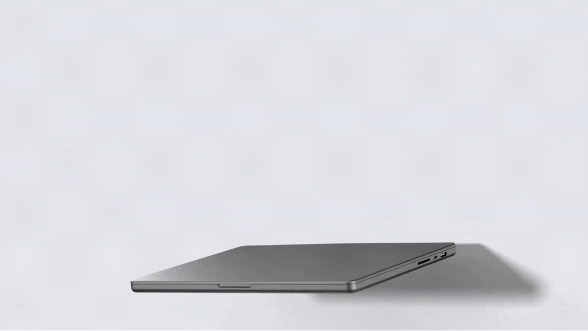 Laptop in various colors rotating against a gray background.
