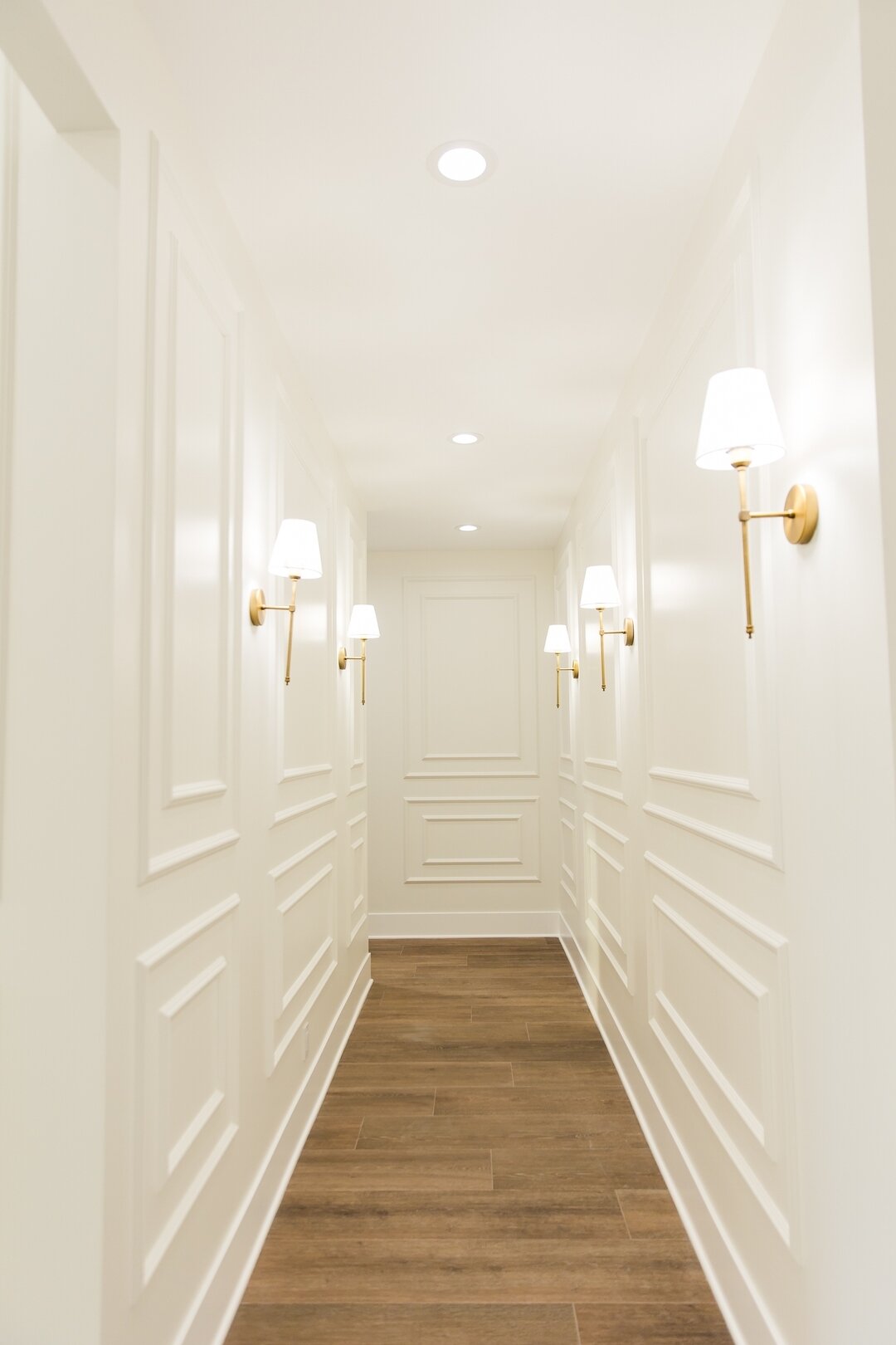 It&rsquo;s all in the details ☁️💡 We helped transform this hallway into an inviting pathway by painting the intricate wall paneling a creamy white
