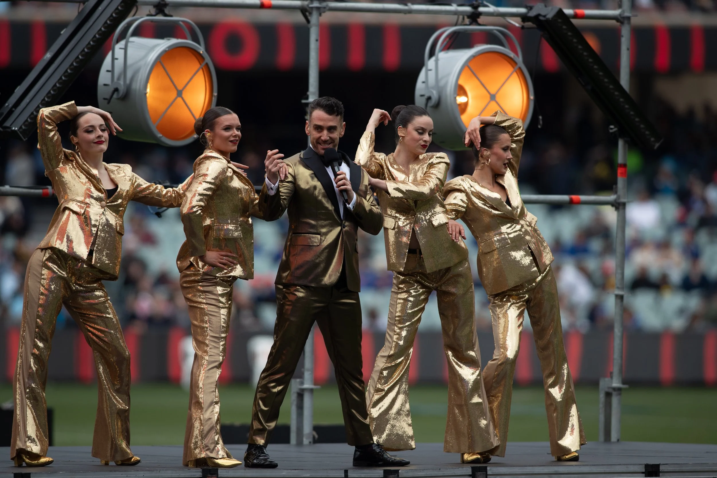 Gold-suited dancers and host performing pre-match at Adelaide Oval