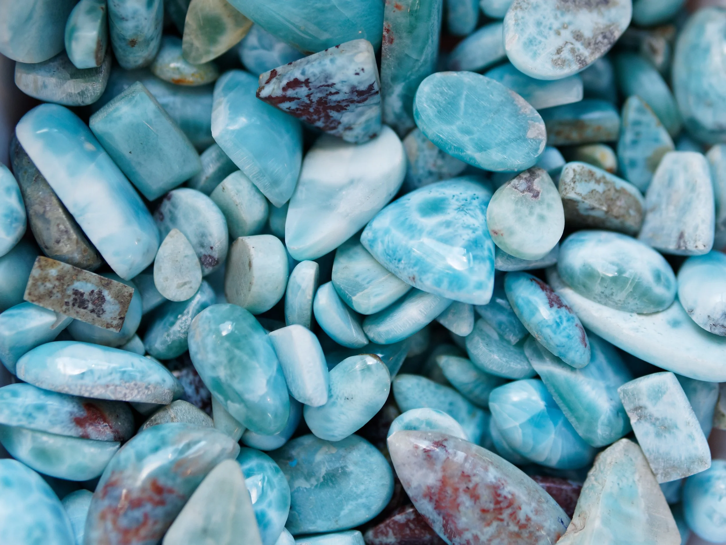 https://images.squarespace-cdn.com/content/v1/641fb82515ba5e5899f28949/2d586ada-65ad-4159-8ca5-5b21b3e32d50/Larimar%2BStones.jpeg