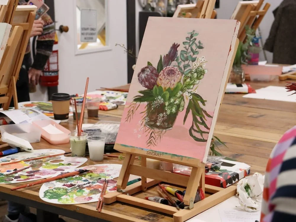 A student painting in the modern Botanical Still life workshop