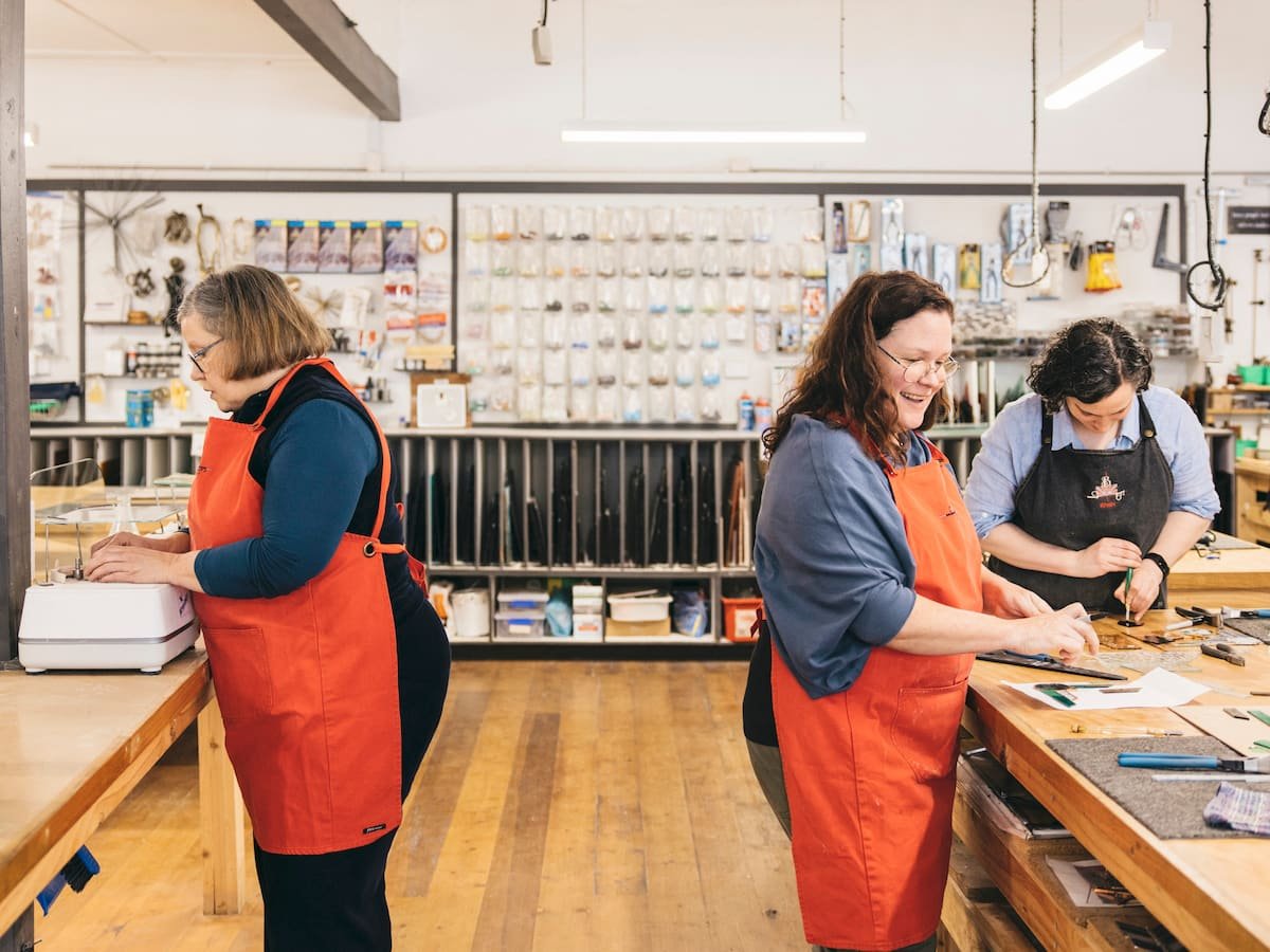 Rhain and Two students in the glass studio cutting and grinding glass