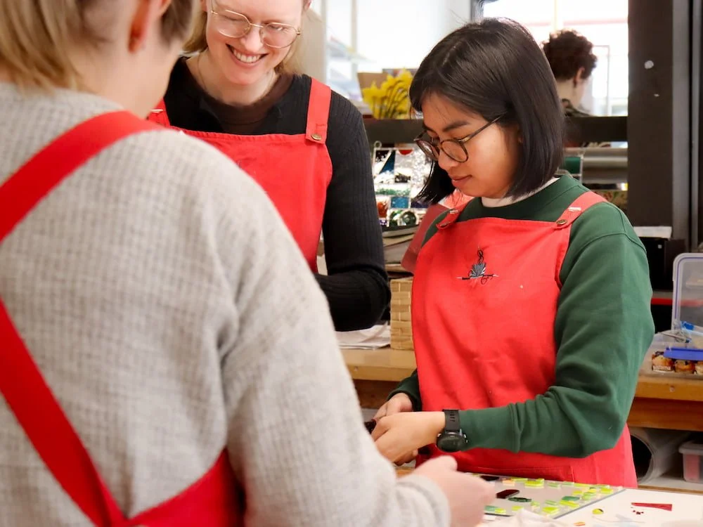 Students making their fused glass platters