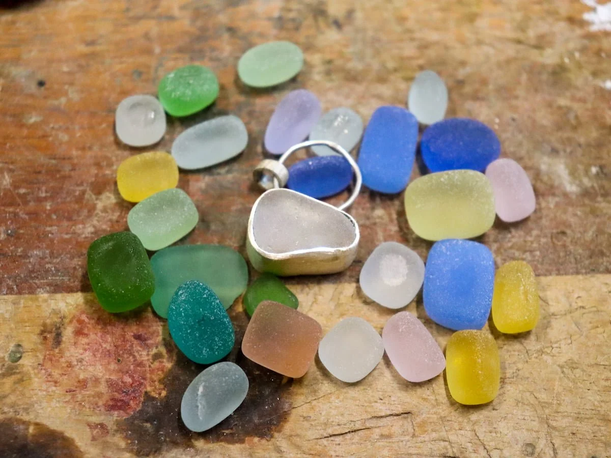 a student's sea glass pendant ready to attach to necklace in class