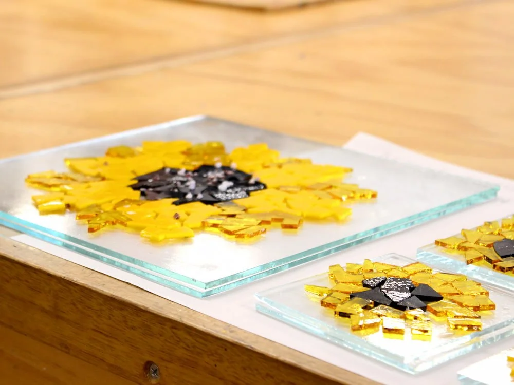 A bright yellow sunflower made in the fused glass workshop