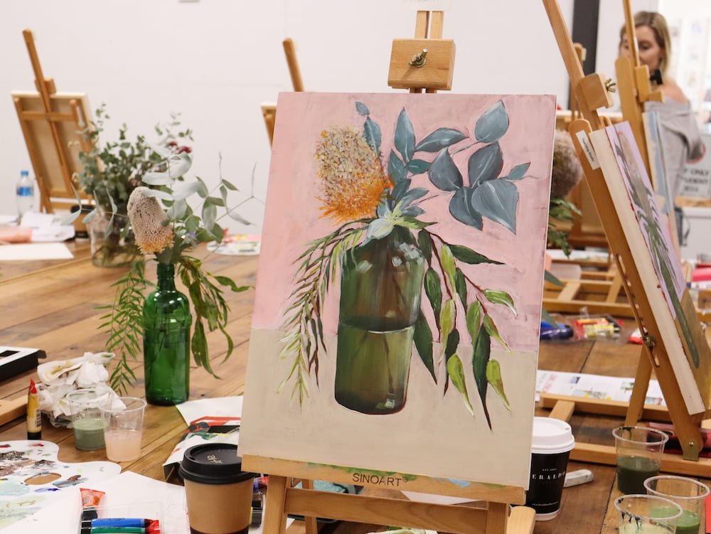 A single bloom with foliage painted by a student in this modern still life acrylic workshop