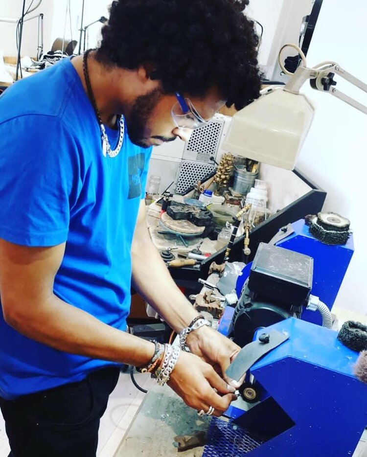  Man working a jeweller’s polishing station 