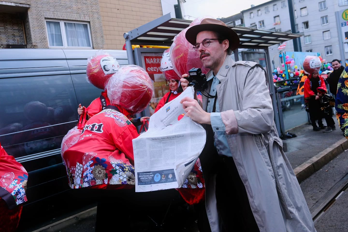 I saw this guy at the parade holding a newspaper. The newspaper he was holding had two holes shaped like eyes. Maybe he was using it to hide his camera? I noticed his Godox, maybe an IM30. I&rsquo;m not sure about his camera. Could be a Holga or a me