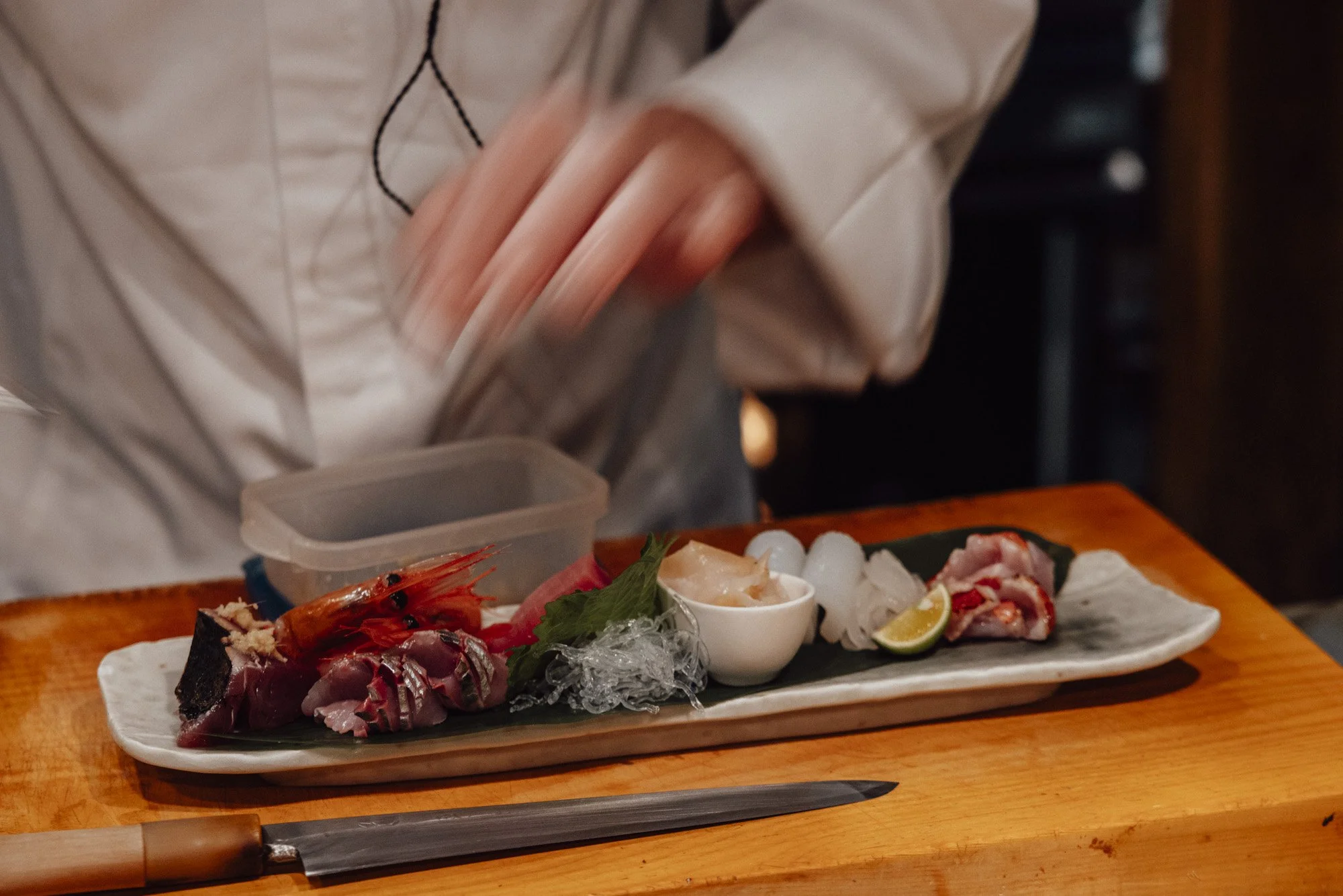 chefs hands preparing a platter of sushi and nigiri at fuwari in kanazawa